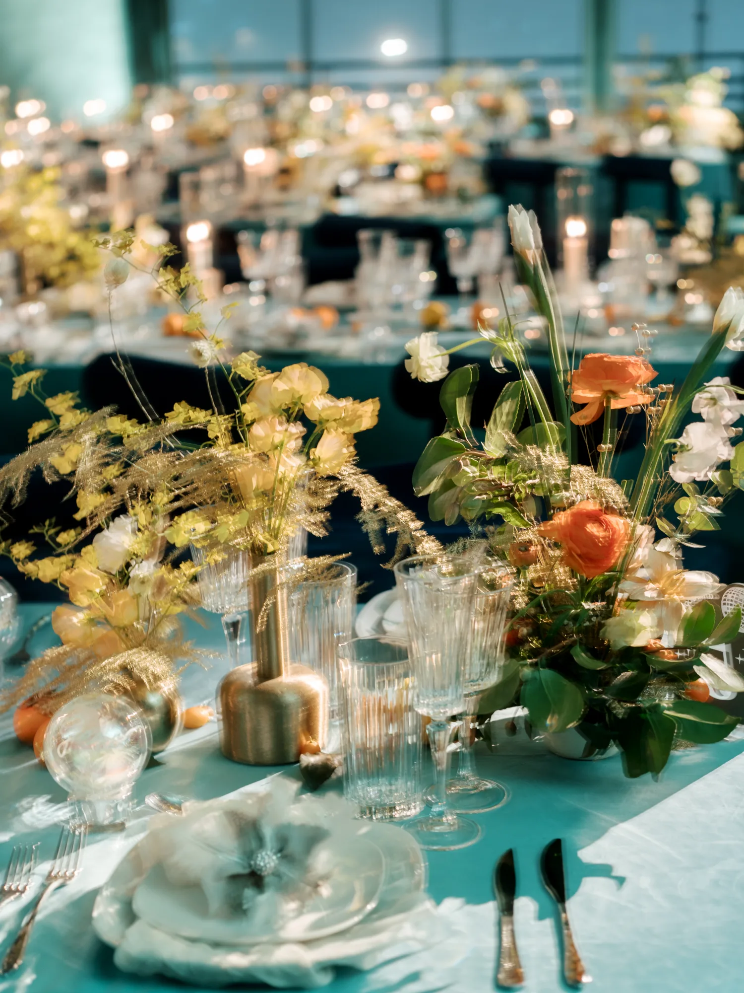 Candlelit wedding reception tables dressed with florals
